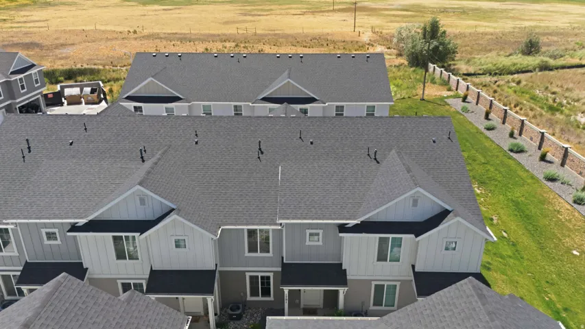 Modern townhome architecture featuring gabled roofs and varied siding textures