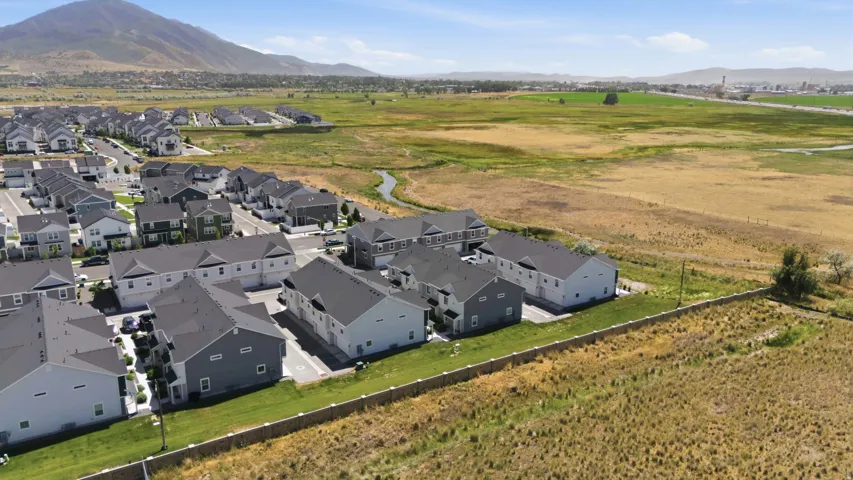 Aerial perspective highlighting a residential community with multi-story homes featuring dark shingle roofs and light-colored siding