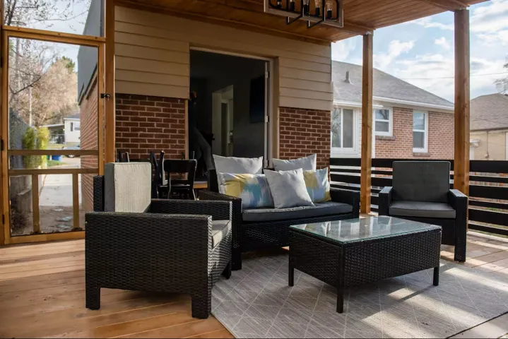 Covered exterior deck with wood-finish flooring and a wood-slat ceiling