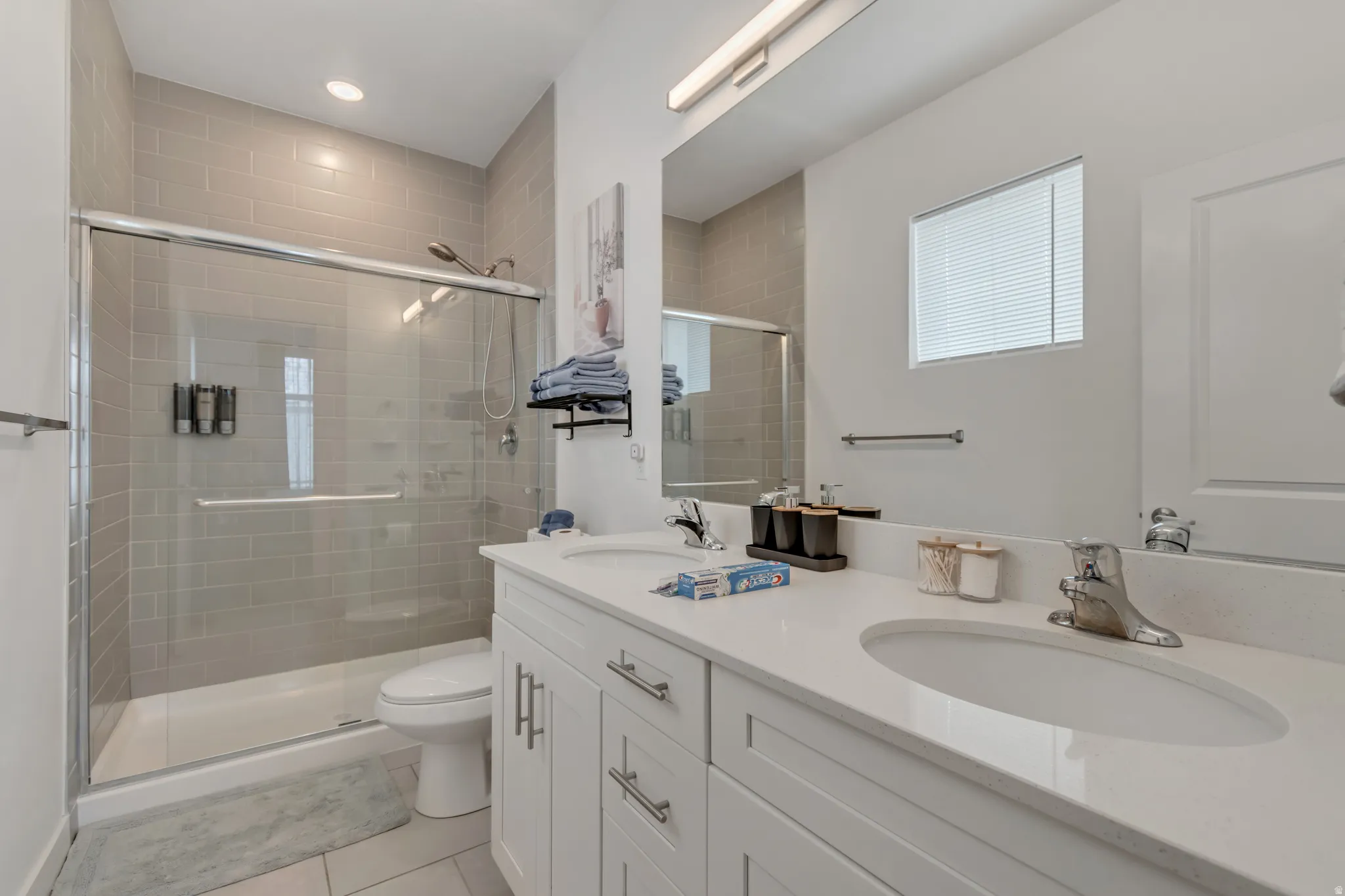 Dual vanity with integrated sinks, white cabinetry, and a spacious countertop