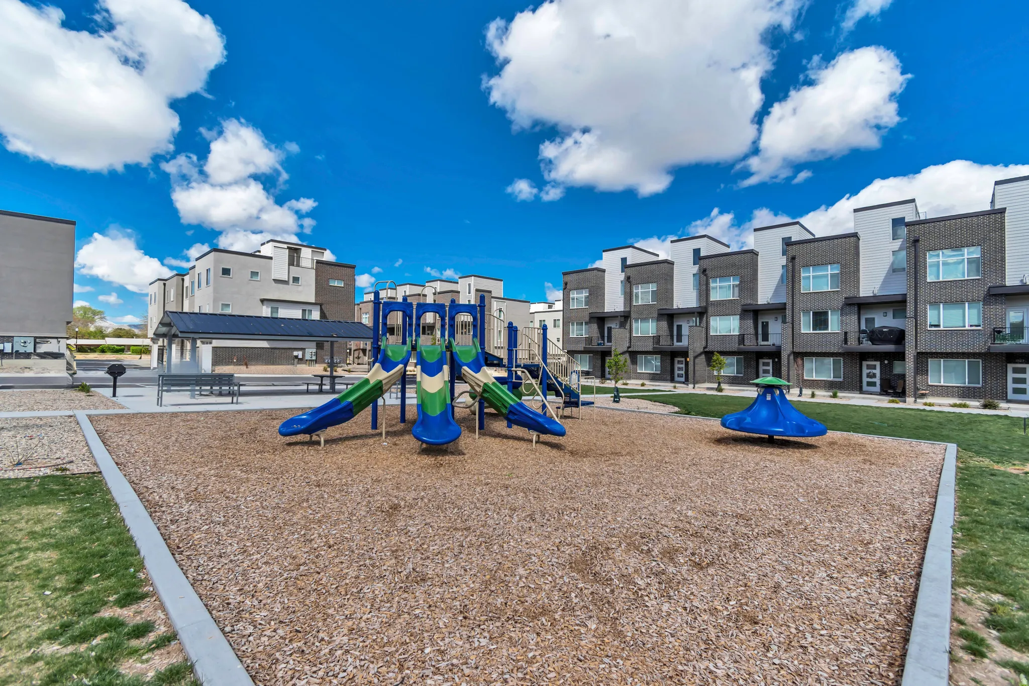 Community playground featuring multiple slides and a spinner