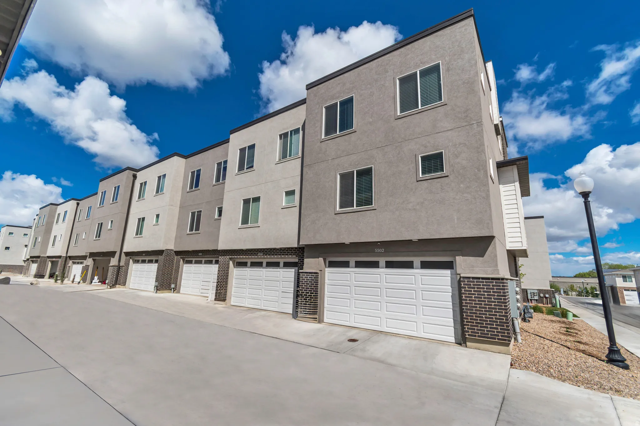 Modern townhome exterior with gray stucco finish