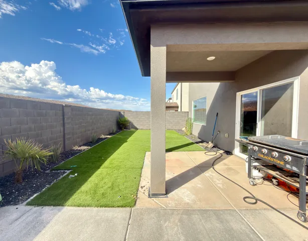 Covered patio featuring concrete flooring and a sliding glass door