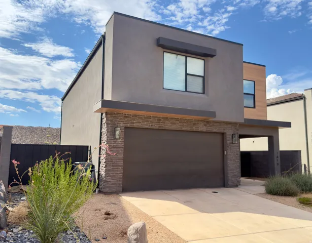 Contemporary two-story exterior featuring a mix of stucco and wood-finish siding