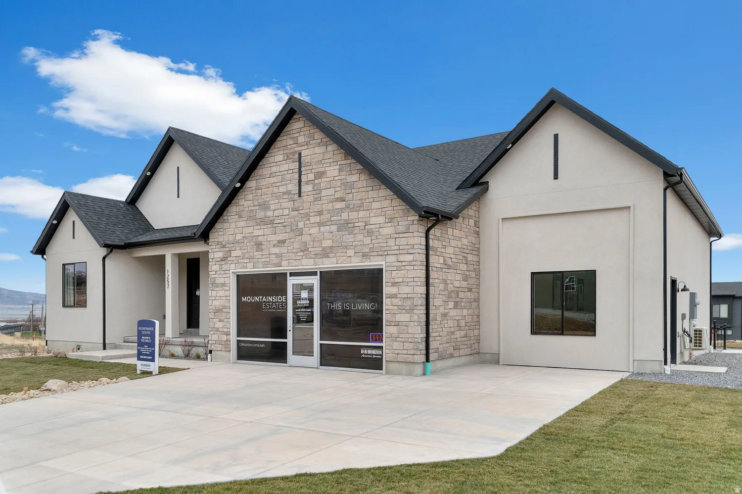 Contemporary exterior featuring stone veneer and stucco finishes