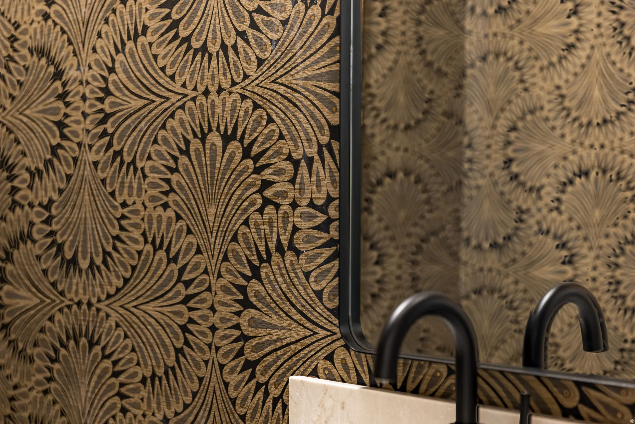 Decorative wallpaper with a repeating fan-like pattern in black and gold tones