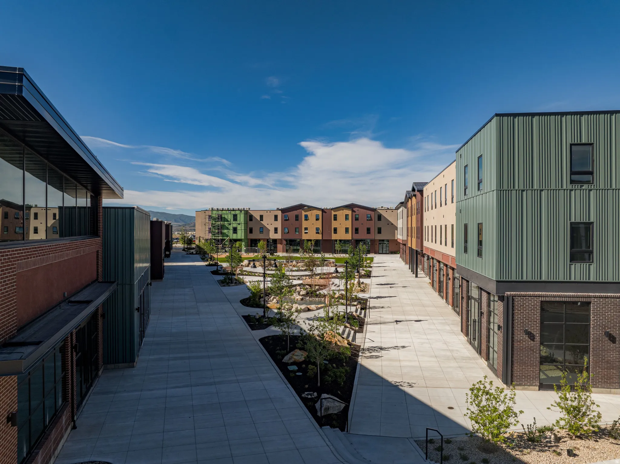 Modern building exteriors with varied cladding, including brick and corrugated metal