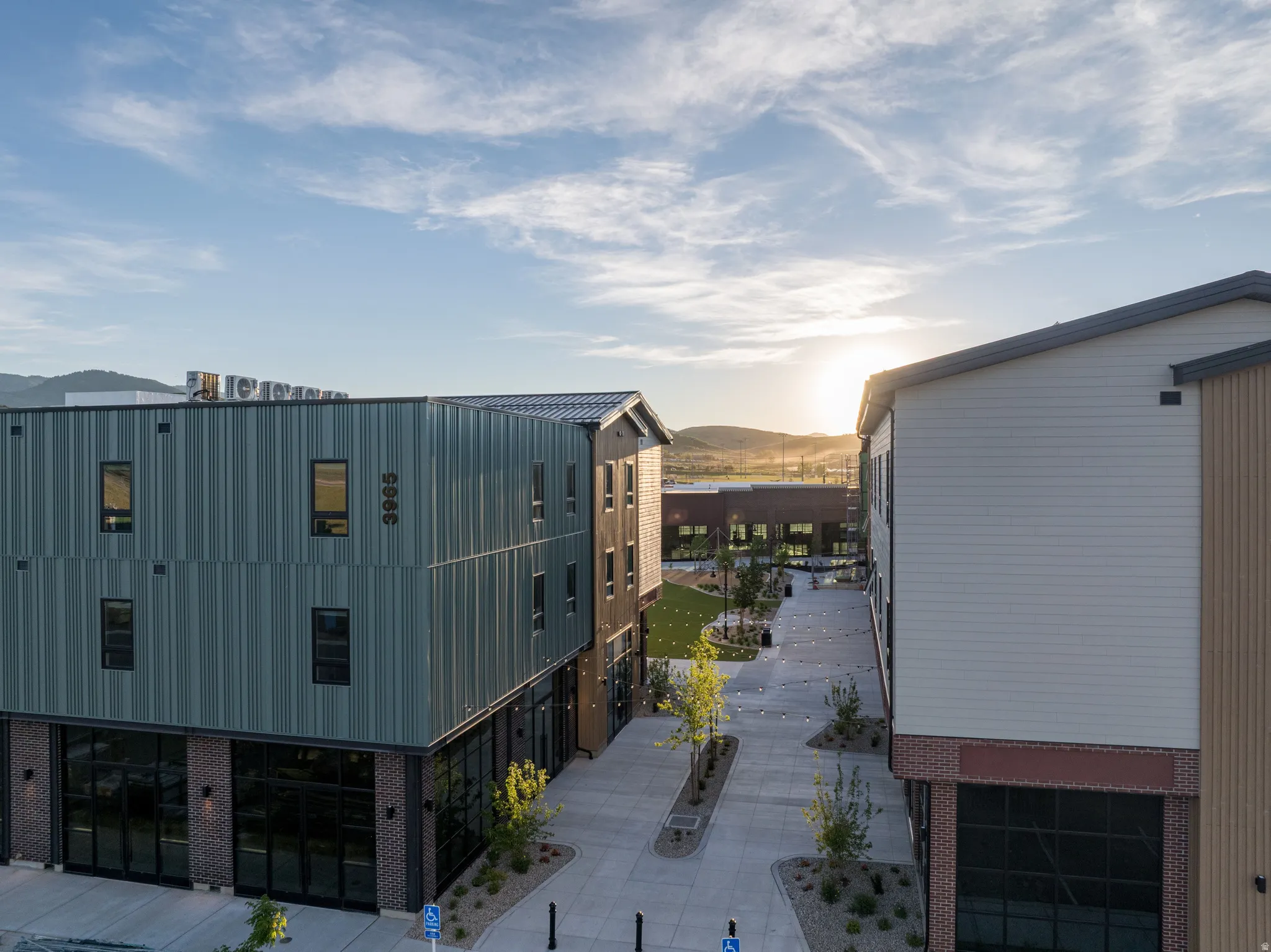 Modern mixed-use buildings featuring multiple material facades including vertical siding, brick, and horizontal panels