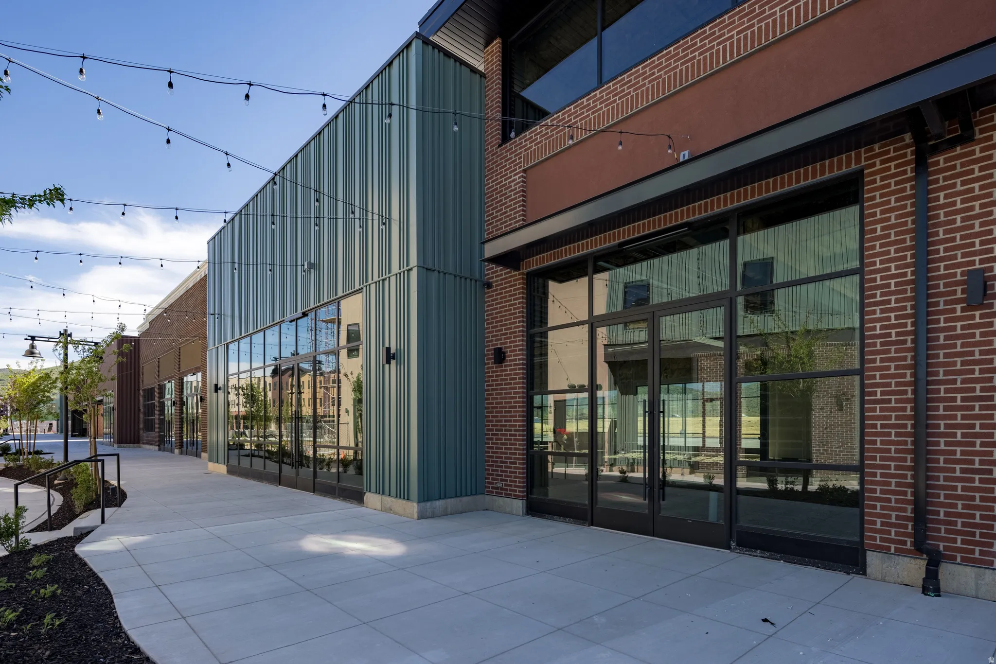 Modern commercial building featuring extensive storefront windows with black framing