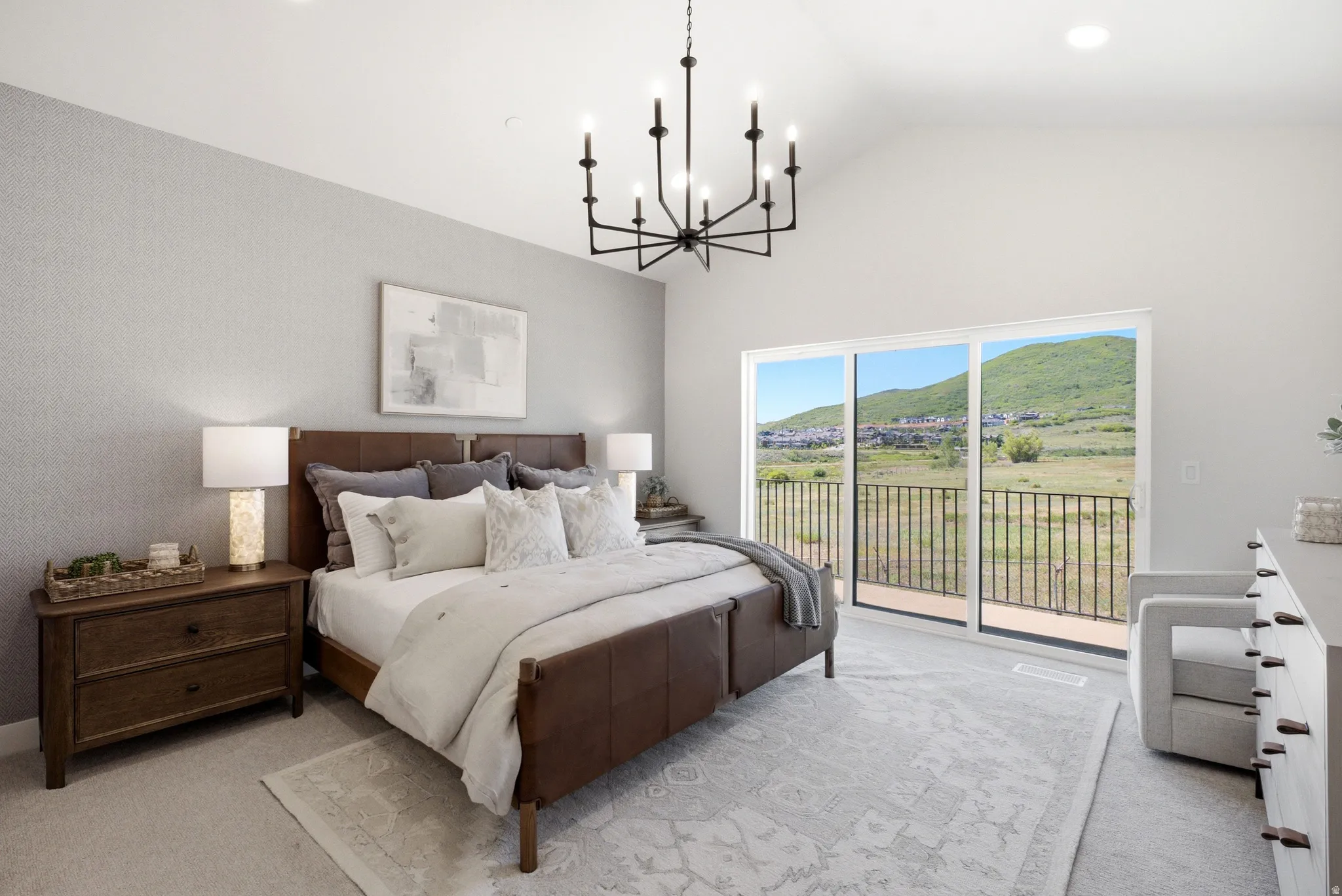 Spacious room with vaulted ceilings and a modern chandelier