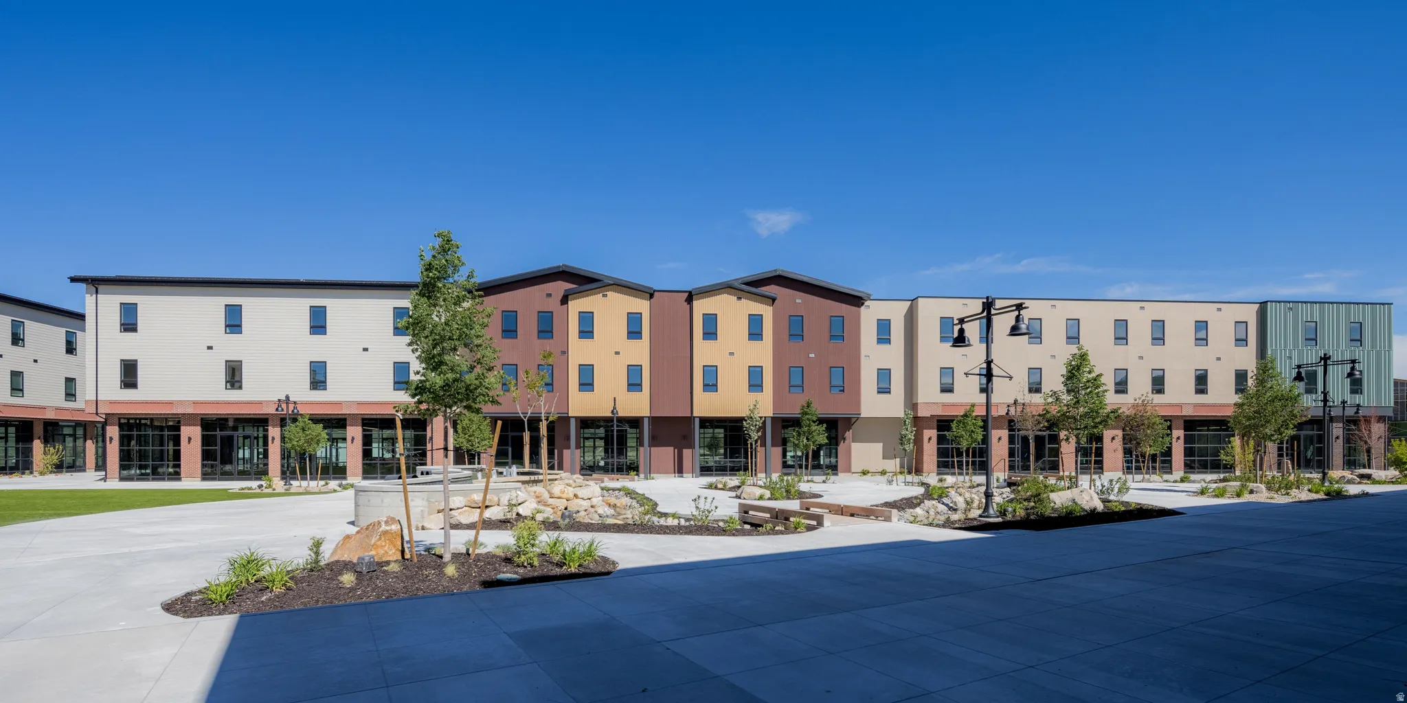 Contemporary multi-story building featuring varied facade colors and textures