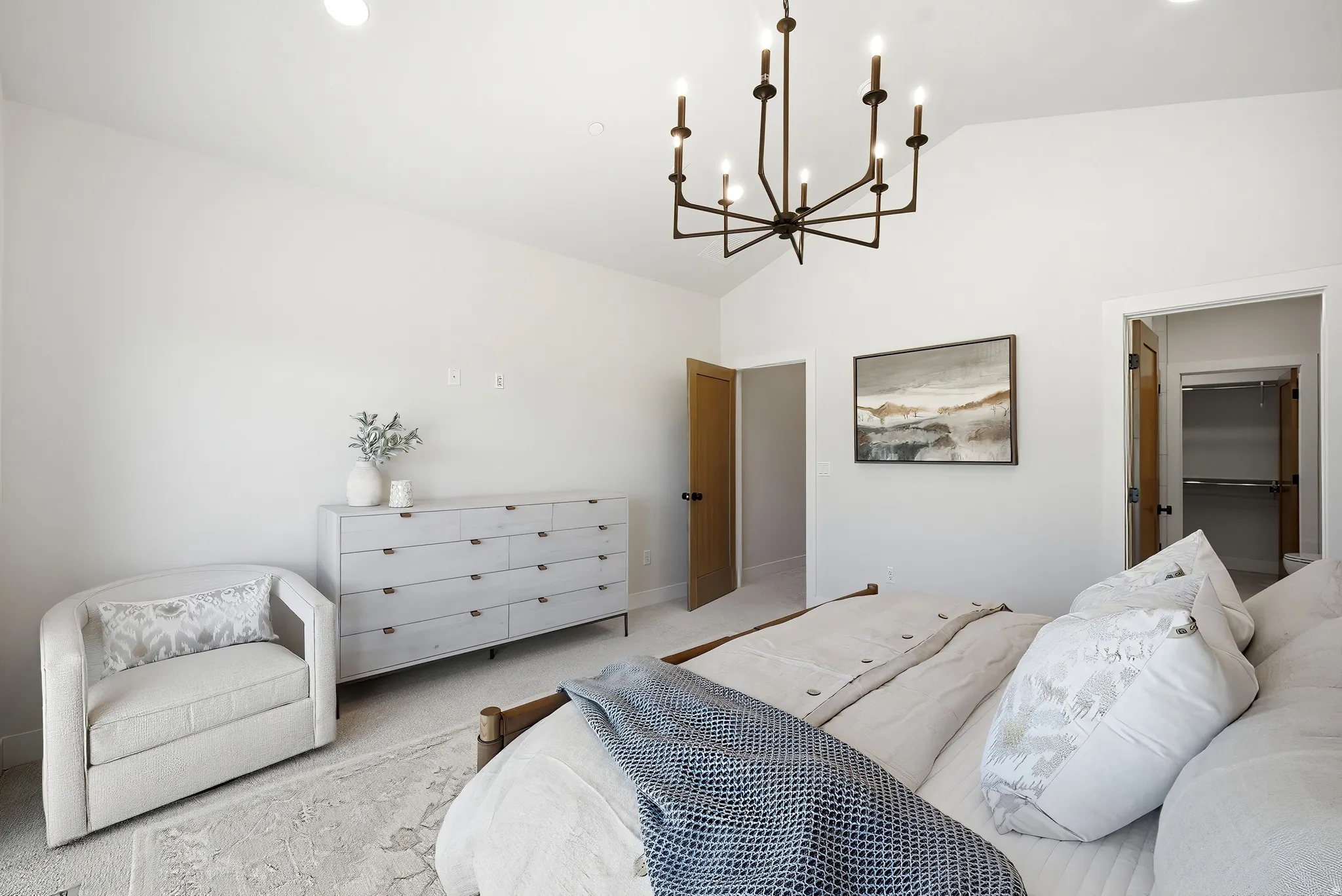 Vaulted ceiling with a contemporary chandelier, recessed lighting, wood-finish doors, and plush carpet flooring