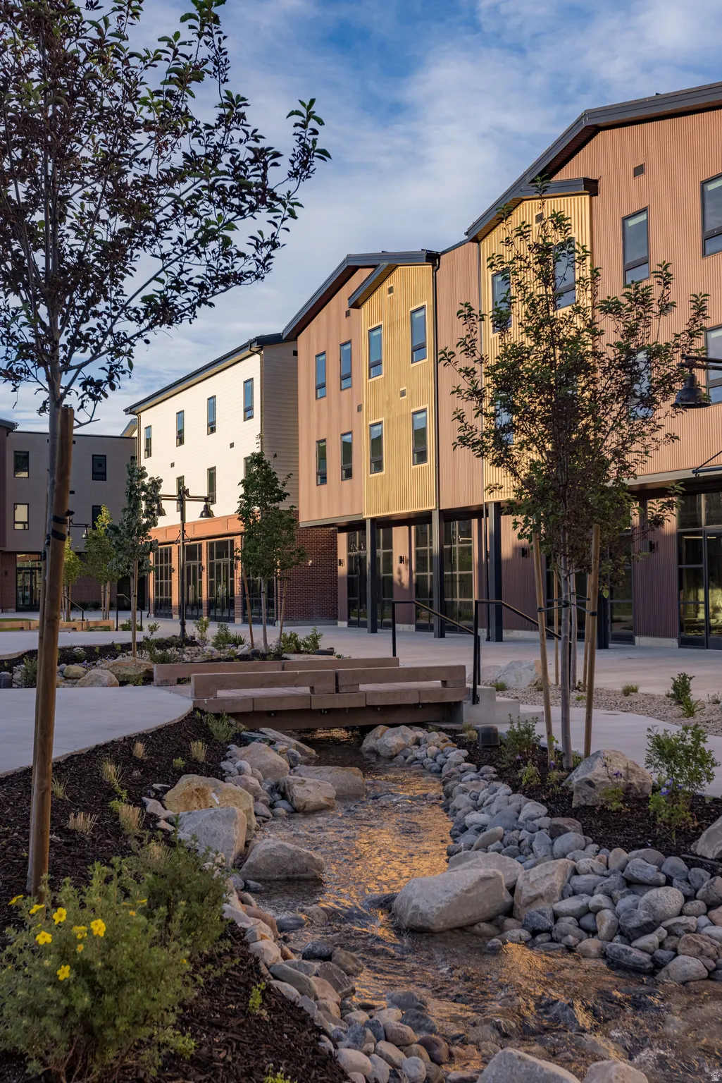 Modern multi-story buildings featuring varied siding finishes and multiple windows