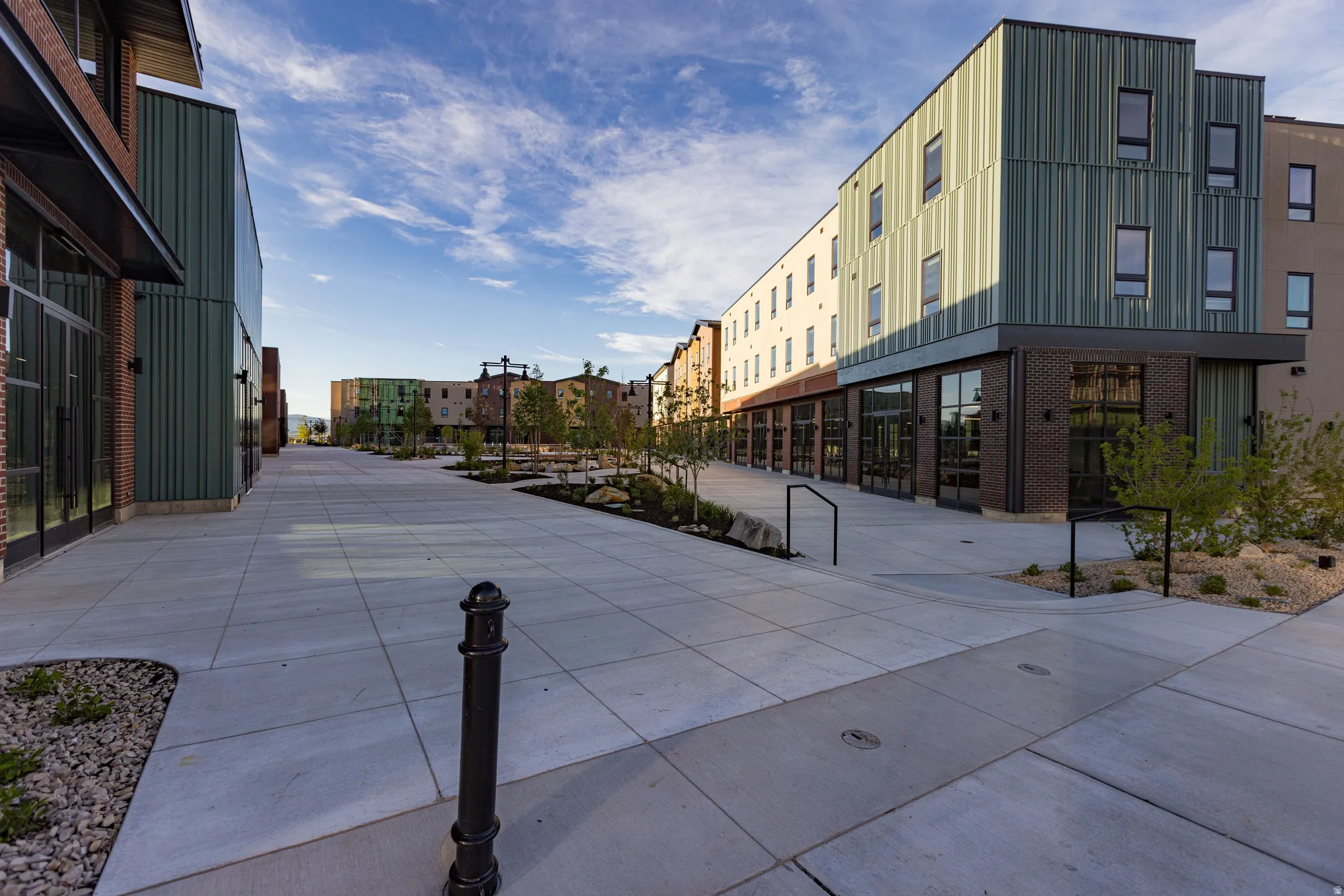 Modern architectural design featuring vertical corrugated metal siding and brick accents