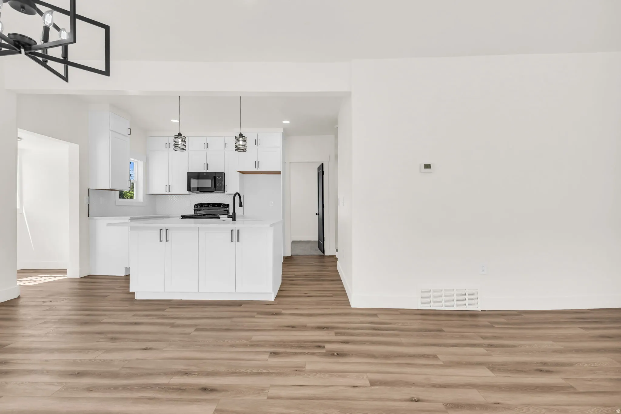 Open-concept living space with wood-finish flooring