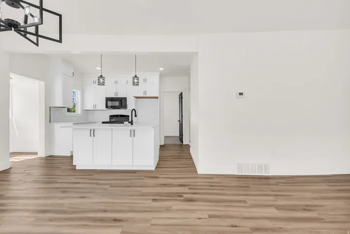 Open-concept living space with wood-finish flooring