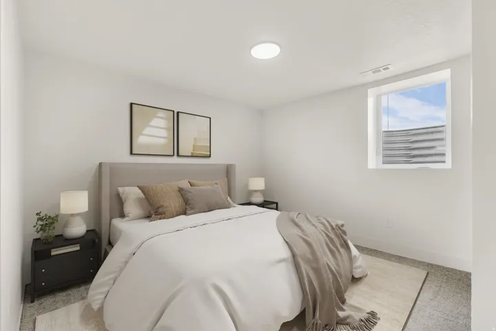 Bright bedroom featuring a single window, white walls, and a flush-mount ceiling light