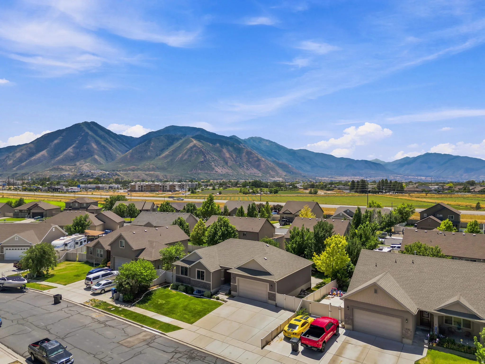 Suburban residential area featuring single-family homes with pitched roofs and attached garages