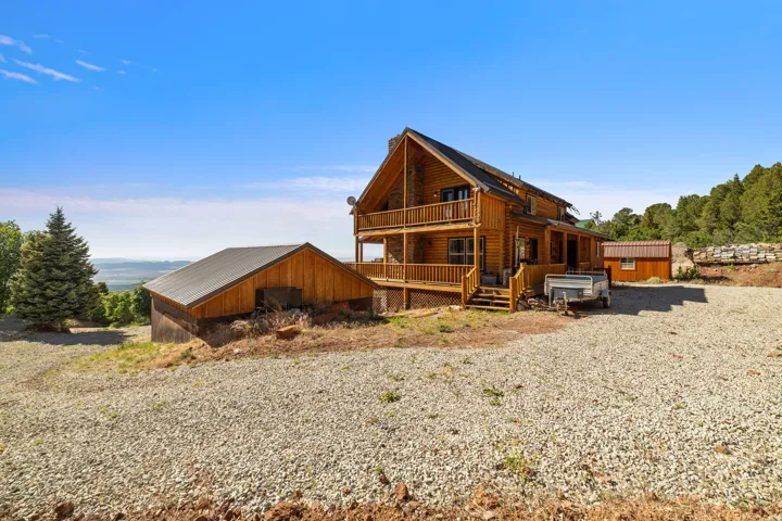 Log home with multiple balconies and an extensive front deck