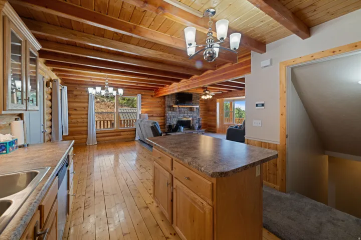 Kitchen island with laminate countertop and light wood cabinetry