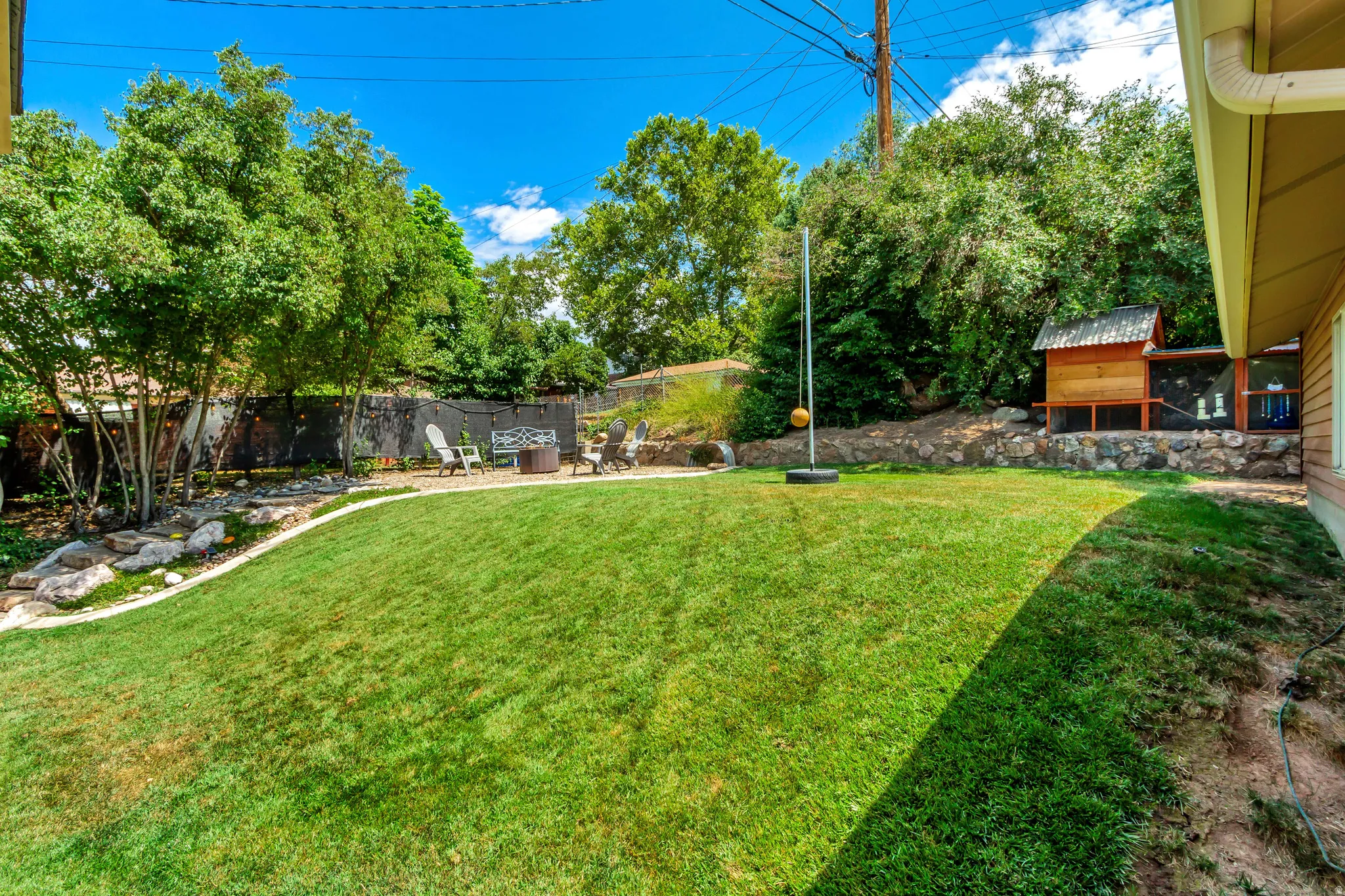 Expansive lawn area with a multi-level design and mature perimeter trees