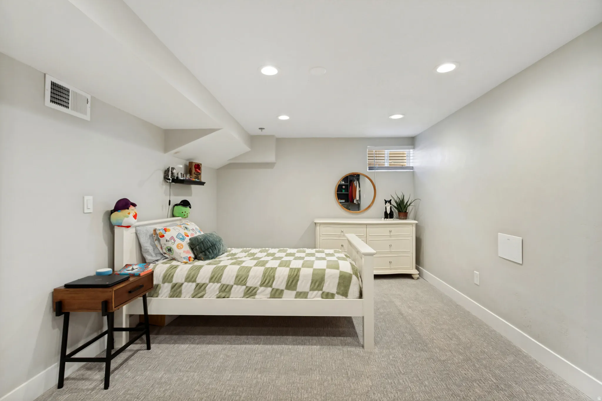 Carpeted room featuring recessed lighting, a white painted baseboard, and a built-in window with horizontal blinds