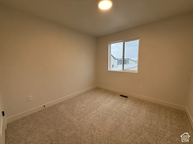 Window with a white frame, overhead flush-mount lighting, and neutral-toned wall paint
