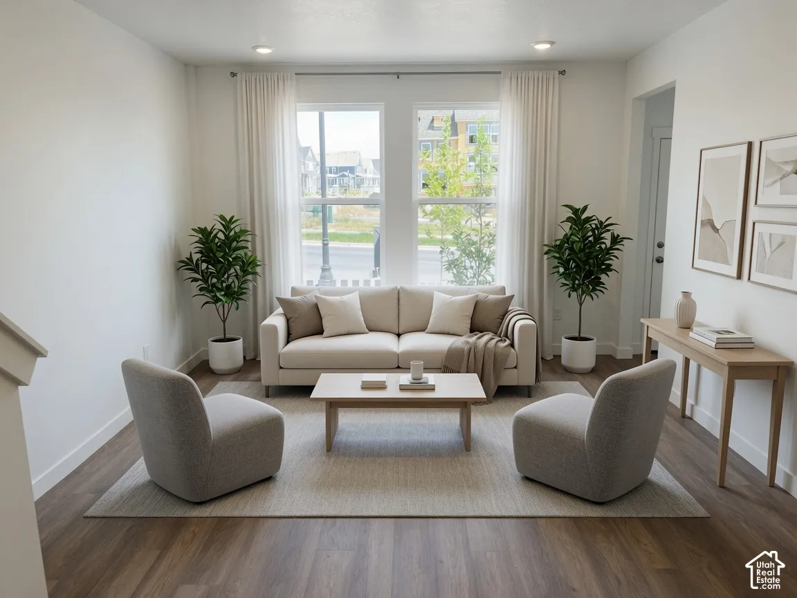 Bright living area featuring wood-finish flooring, recessed lighting, and a neutral color palette