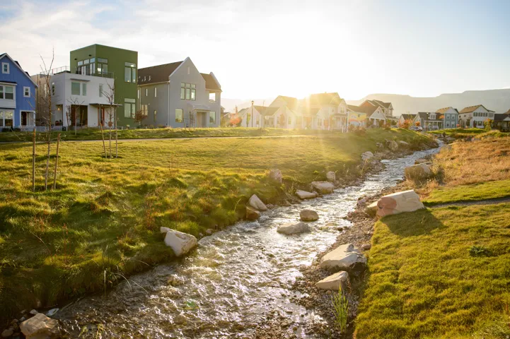 Winding stream featuring natural rock accents and a surrounding grassy landscape
