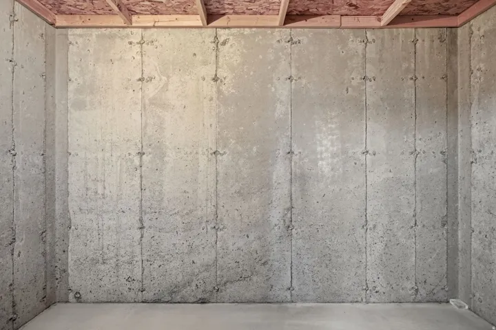 Concrete wall construction with visible formwork lines