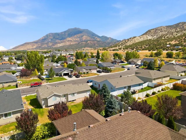 Residential neighborhood featuring single-story homes with shingle roofs and fenced backyards