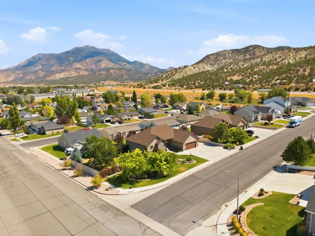 Residential neighborhood featuring a paved street system, landscaped properties, and mountain backdrop