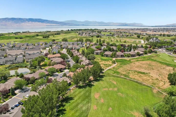 Aerial perspective showcasing a residential community with varied rooflines and surrounding green spaces