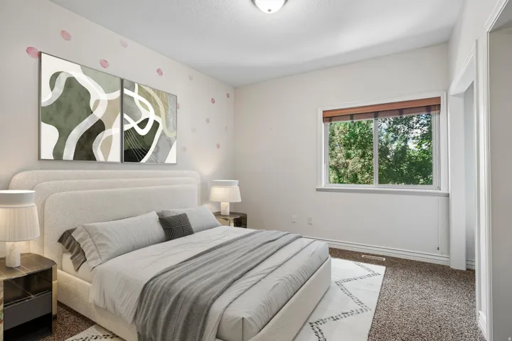 Carpeted room featuring a double-pane window with wood-finish blinds, white trim throughout, and a ceiling-mounted light fixture