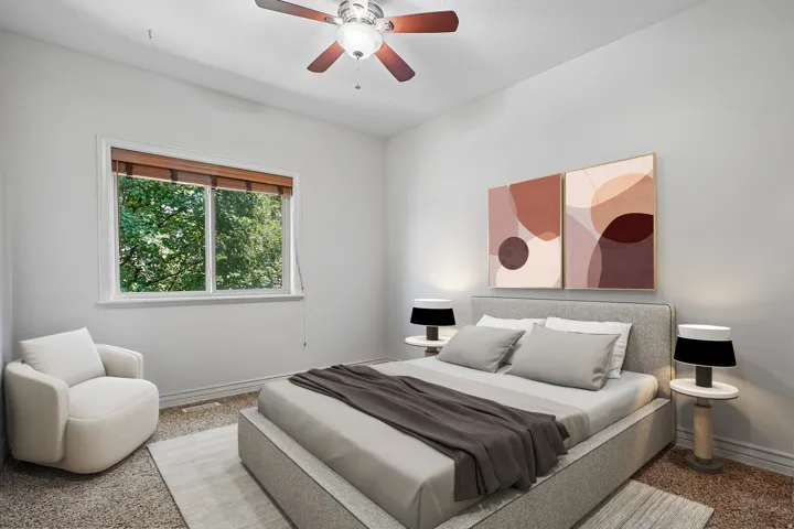 Bedroom featuring a large window with wood-finish blinds, a ceiling fan with wood-finish blades, and neutral-toned wall paint