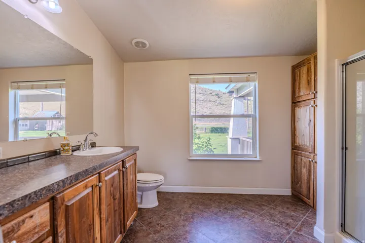 Wood-finish vanity with an integrated sink and laminate countertop