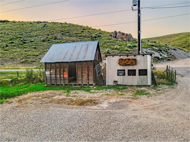 Gravel parking area fronting two utility structures
