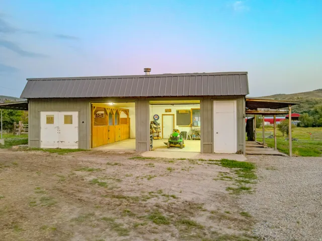 Front view of detached shop/garage showcasing two horse stalls