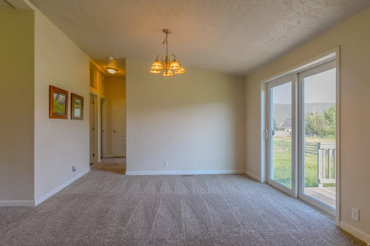Bright interior space featuring light-colored walls and patterned carpet flooring