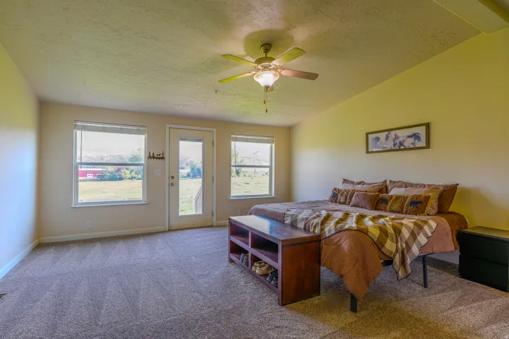 Owners Suite featuring a vaulted ceiling and a ceiling fan with integrated lighting