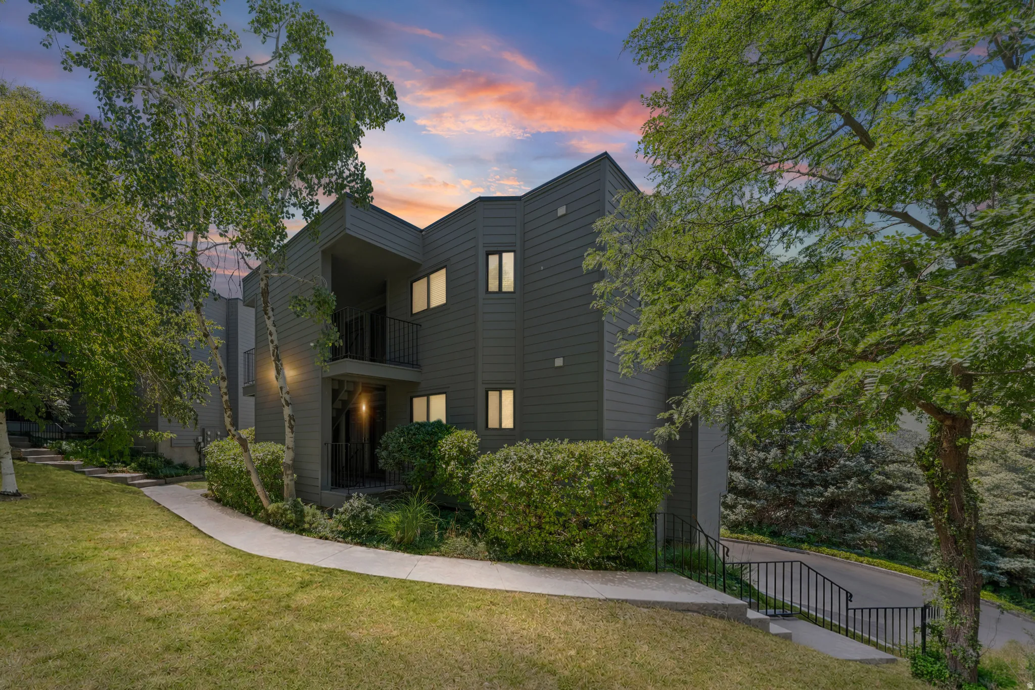 Contemporary multi-story facade featuring dark-toned siding and multiple windows