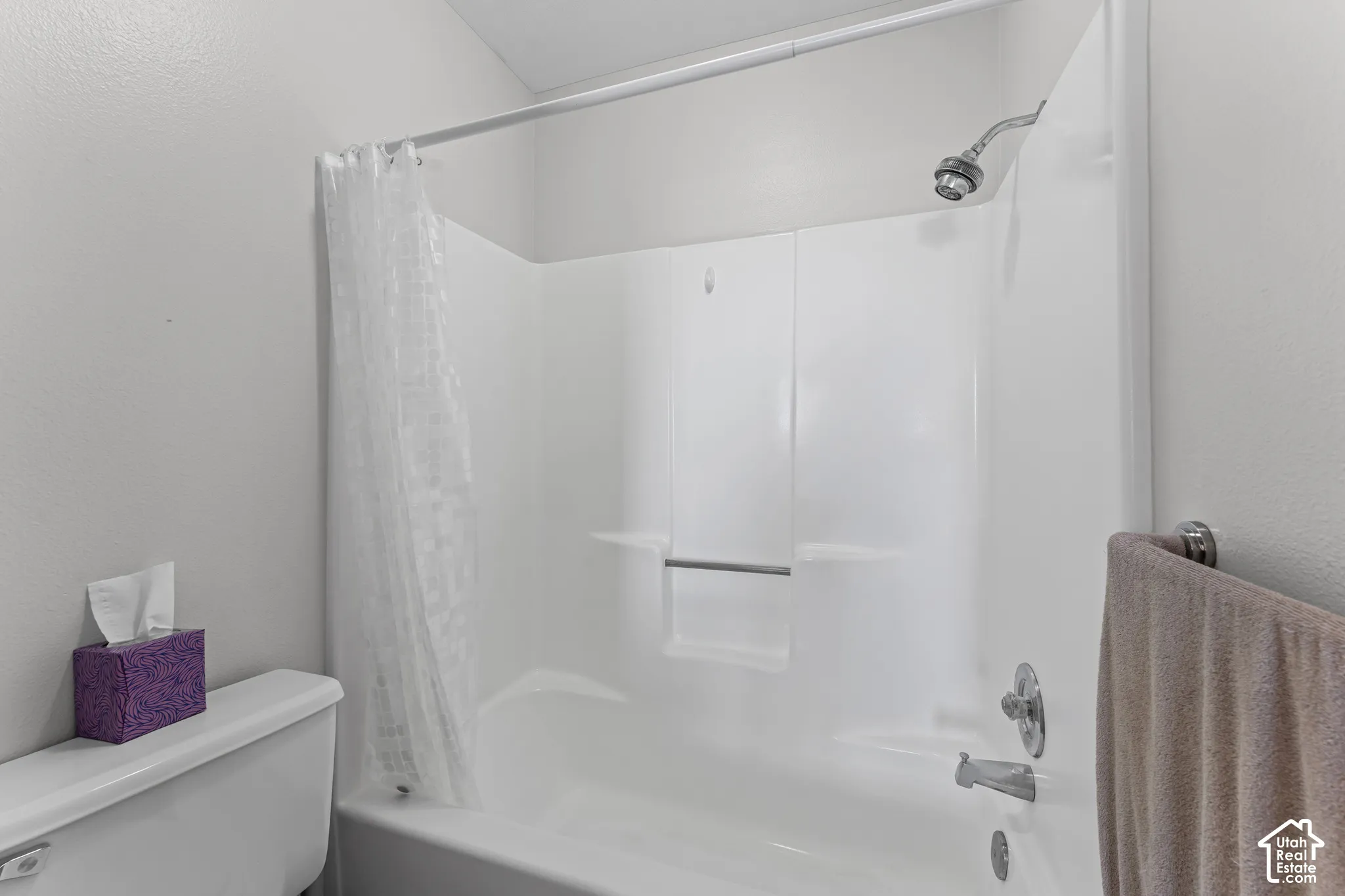 White acrylic tub/shower combination featuring chrome fixtures