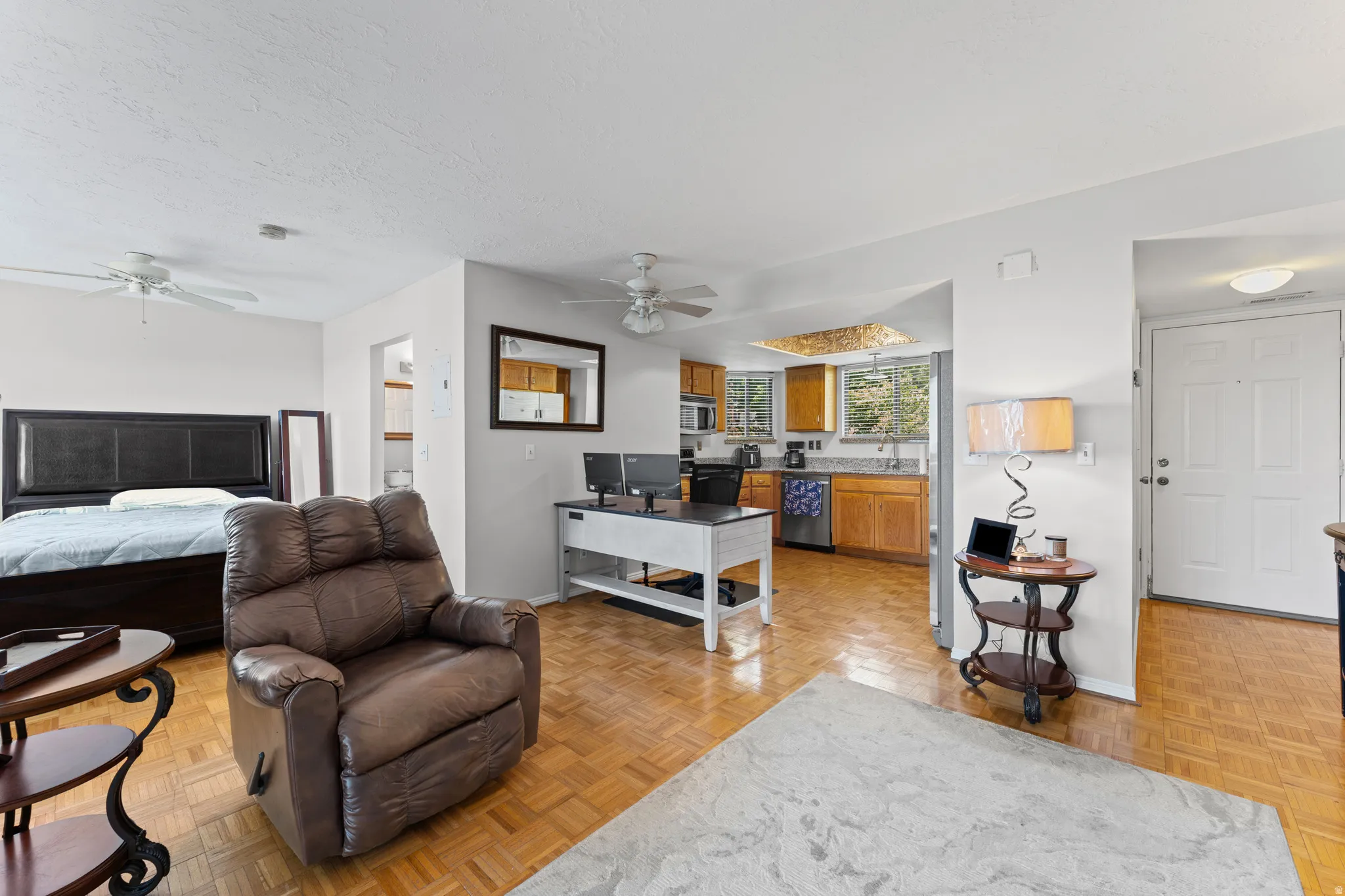 Open concept living area featuring wood-finish parquet flooring throughout