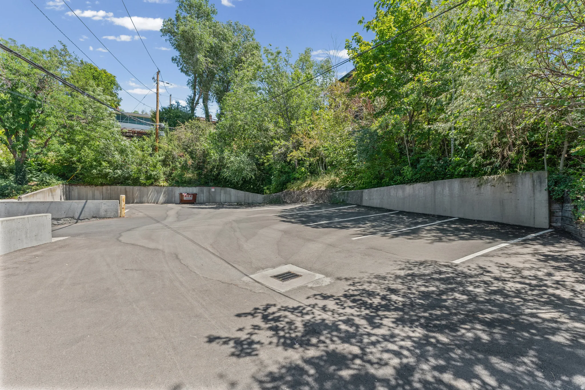 Paved parking area with concrete retaining walls and marked parking spaces