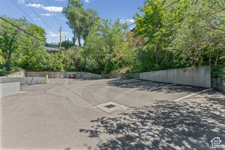 Paved parking area with concrete retaining walls and marked parking spaces