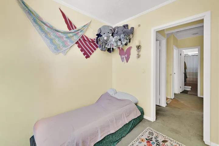Carpeted room with a doorway opening to a hallway