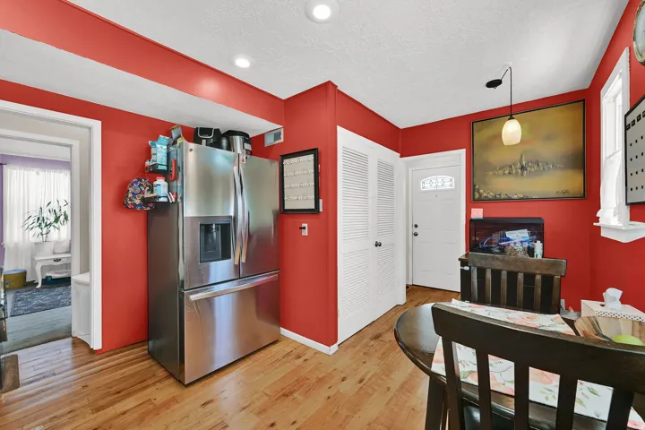 Kitchen area featuring wood-finish flooring, recessed lighting, and a prominent stainless steel refrigerator