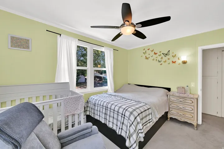Room with light green walls and white crown molding