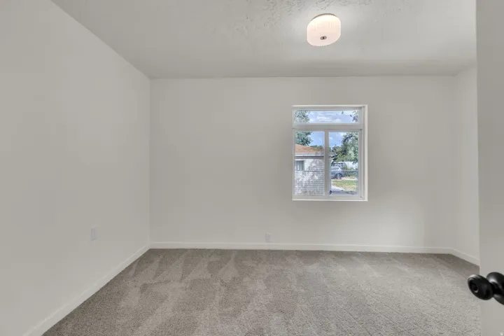 Neutral-toned carpeting and white walls