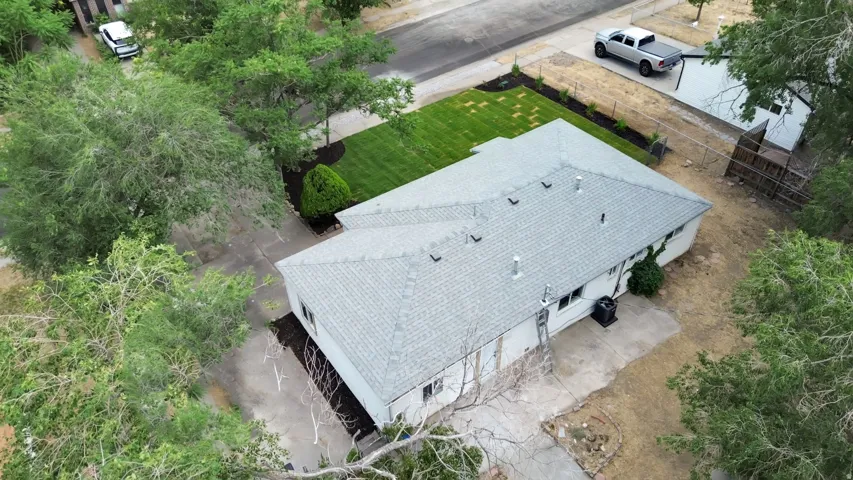 Aerial perspective showcasing a single-story residence with a gray shingle roof